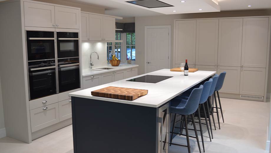 Grey shaker kitchen with navy blue kitchen island