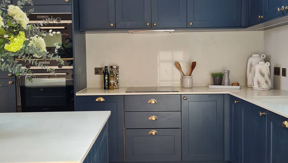 Cup and knob handles in a blue kitchen