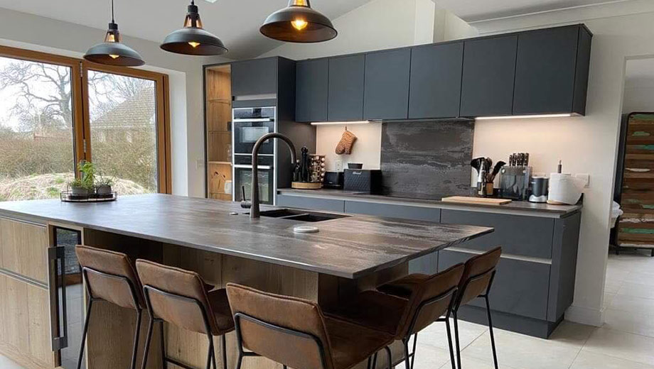 Dark modern kitchen featuring kitchen island