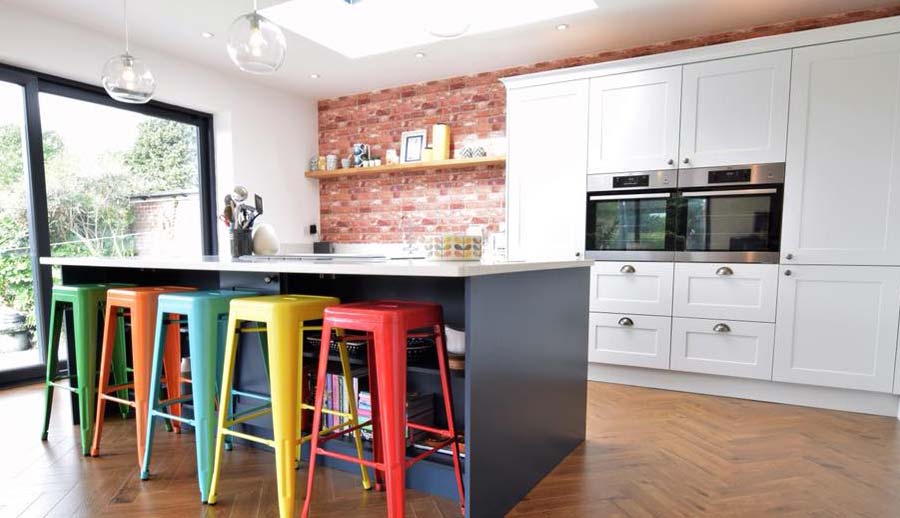 Grey kitchen featuring kitchen island and feature wall