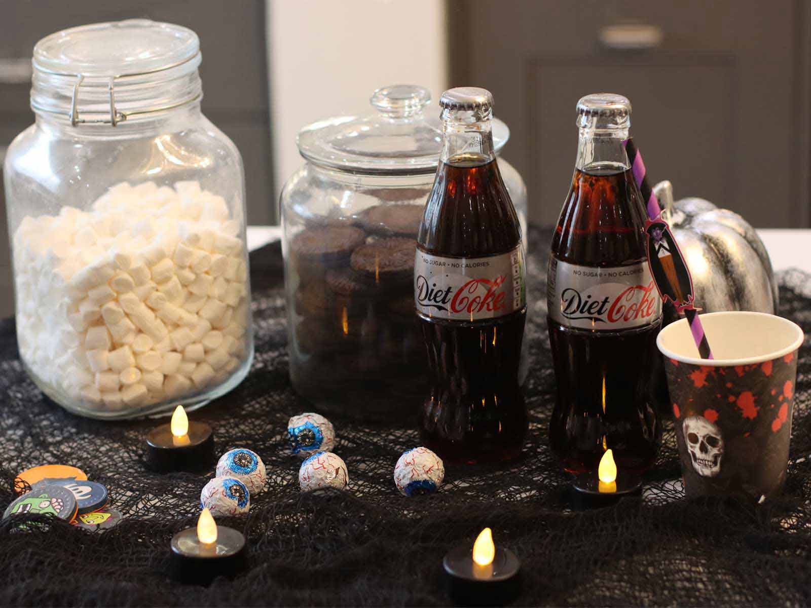 Halloween party drinks for kids, along with biscuits and props