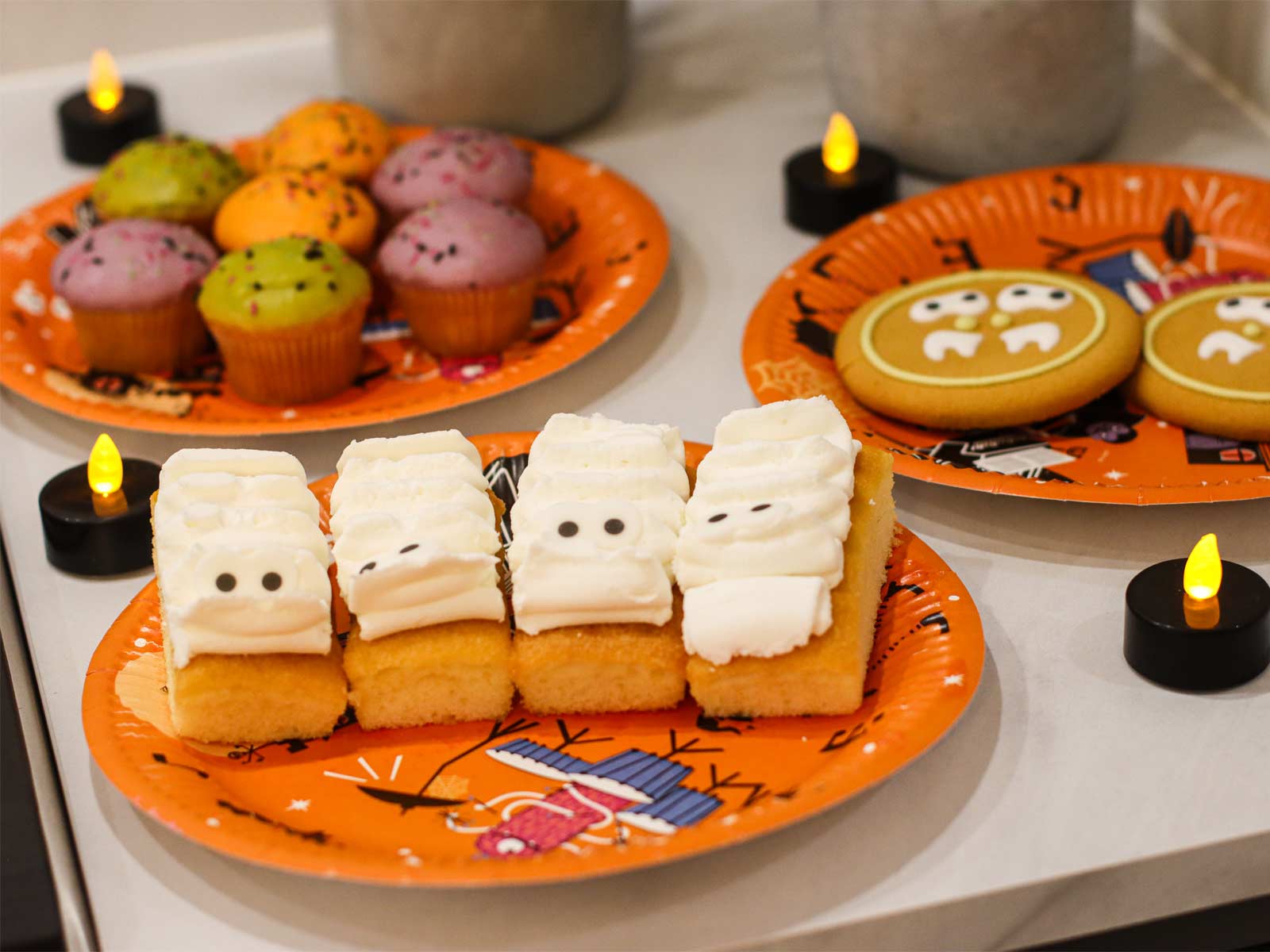 Halloween party treats for kids, including cupcakes and biscuits