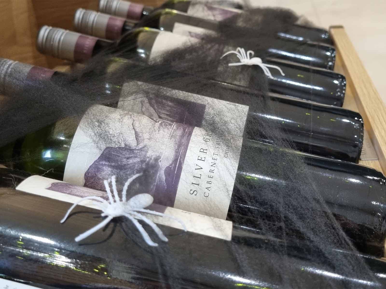 A wine rack cabinet insert full of spiders and wine in a wine drawer