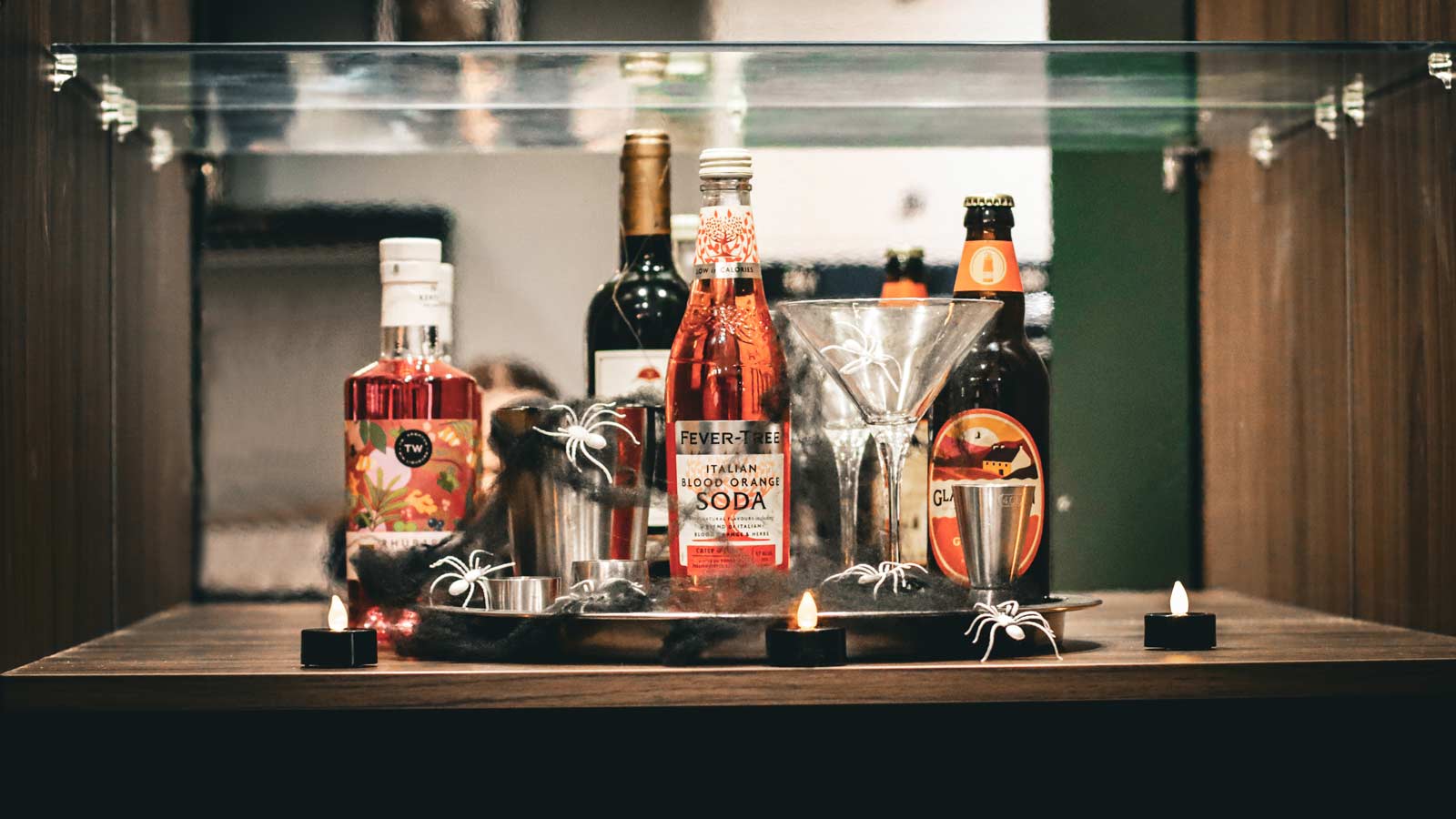 A tall drinks cabinet fitted with a range of Halloween-themed drinks