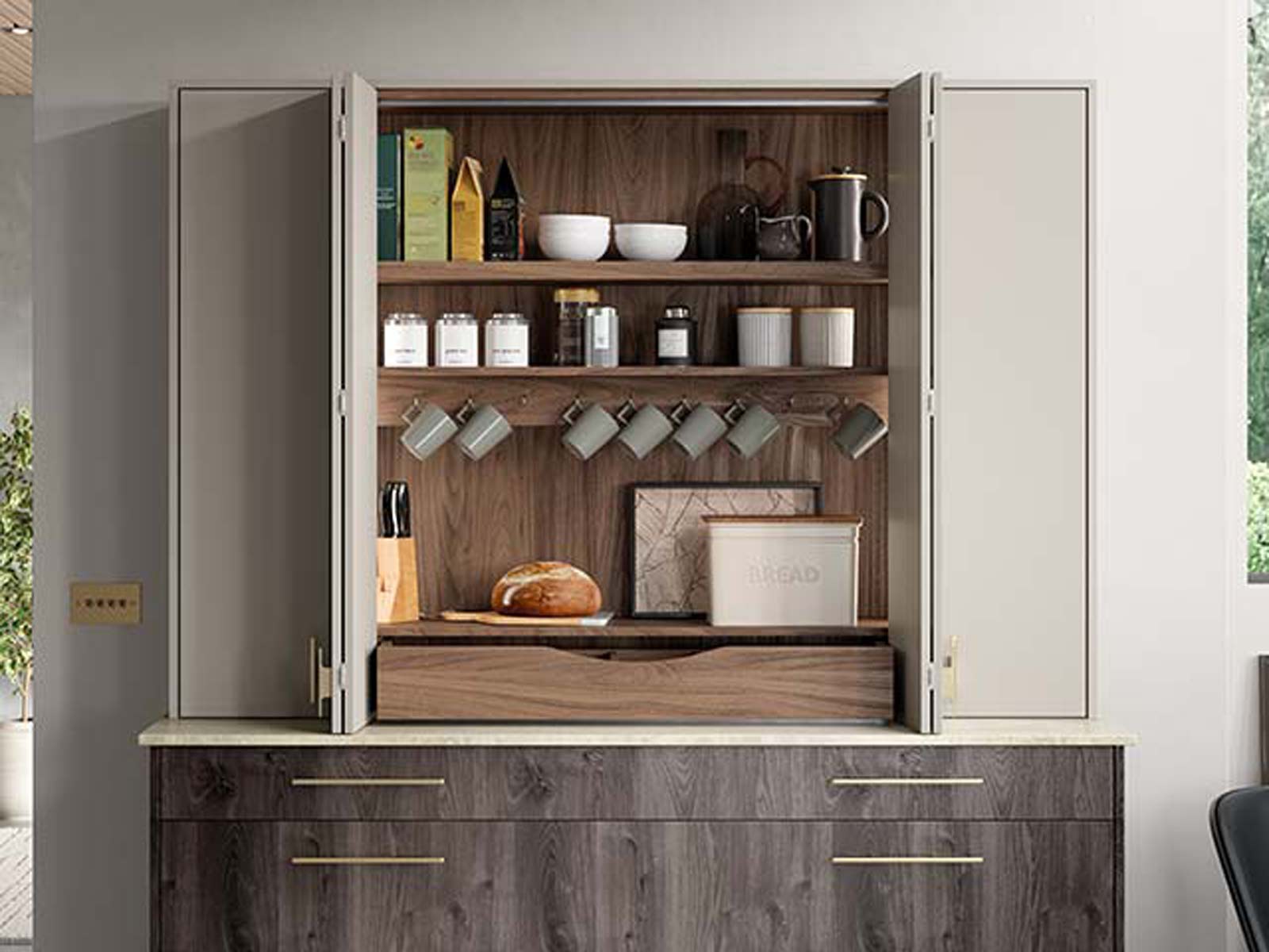 A tea and coffee station in a kitchen breakfast dresser unit with bi-fold doors
