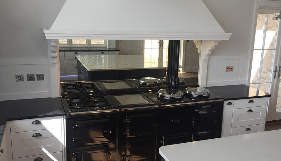 Mirrored splashback in a grey shaker kitchen