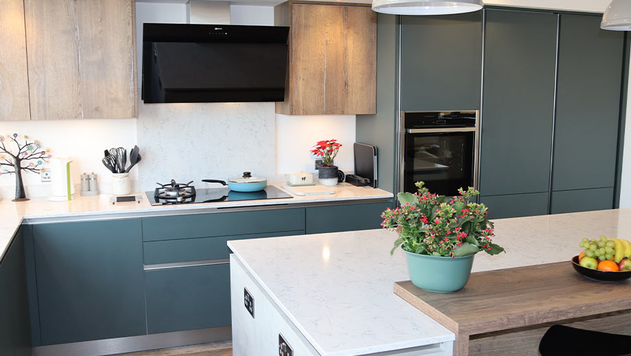 Modern green kitchen with wood-effect upper cabinets