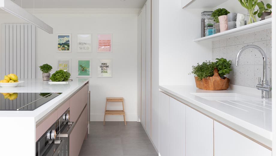 Pink and grey kitchen cabinets in an open plan kitchen